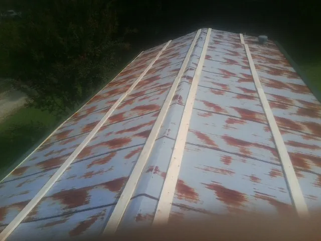 Rusted metal roof panels with new wood purlins before replacement — Storm Damage Roof Repair in Palermo by Roofing Brothers
